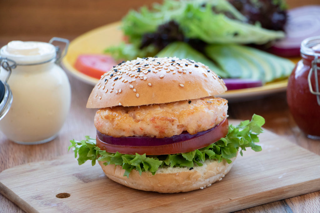 Organic Ocean shrimp burger plated on wood serving board